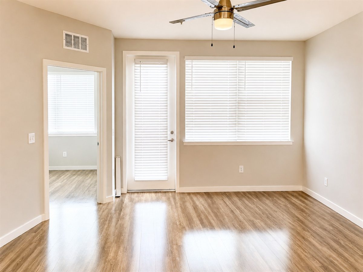 Empty, freshly cleaned room with bare floors and clean windows, ready for new occupants