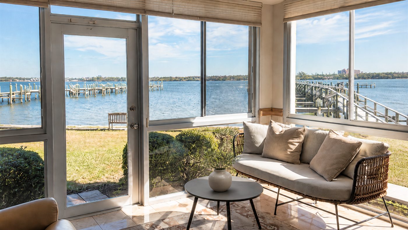 Sunlit waterfront sitting room in a vacation rental, cleaned and reset for the next guest